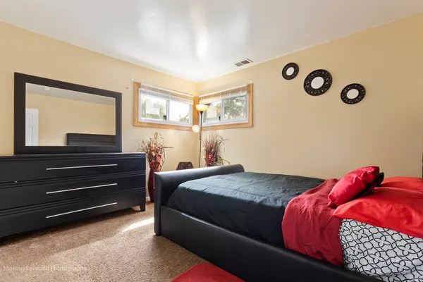 a bedroom with a bed and a dresser