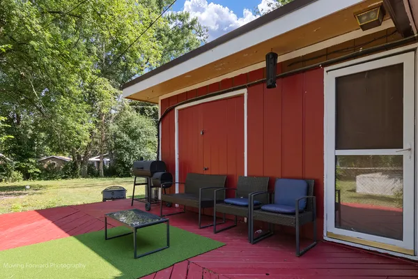 a backyard of a house with outdoor seating