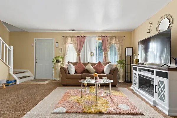 a living room with furniture a rug and a fireplace