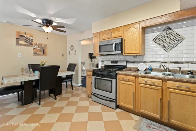 a kitchen with a sink stove and microwave