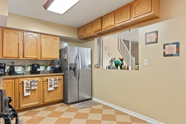a kitchen with stainless steel appliances a refrigerator and cabinets