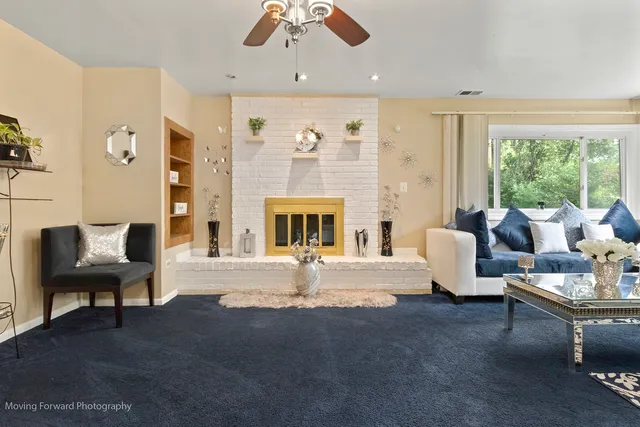 a living room with furniture and a fireplace