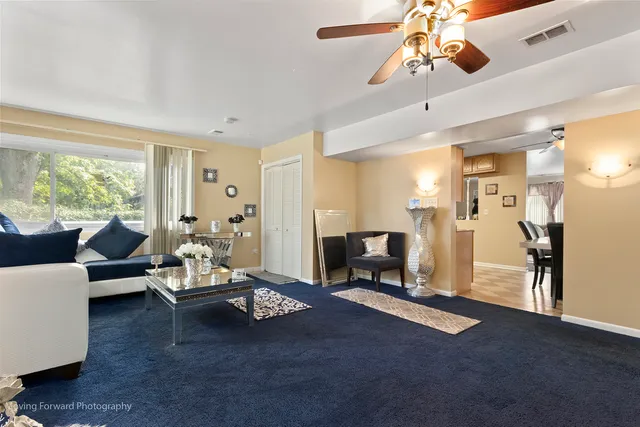 a living room with furniture windows and a chandelier