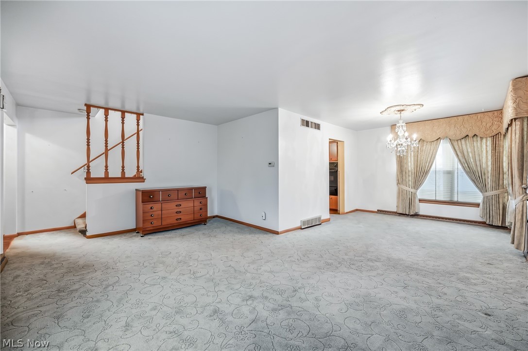 267 Butler Road Northeast Warren, OH 44483 - Photo 18 of 50 Unfurnished room featuring light carpet and hanging lights