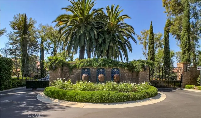 a front view of a house with a yard and palm trees