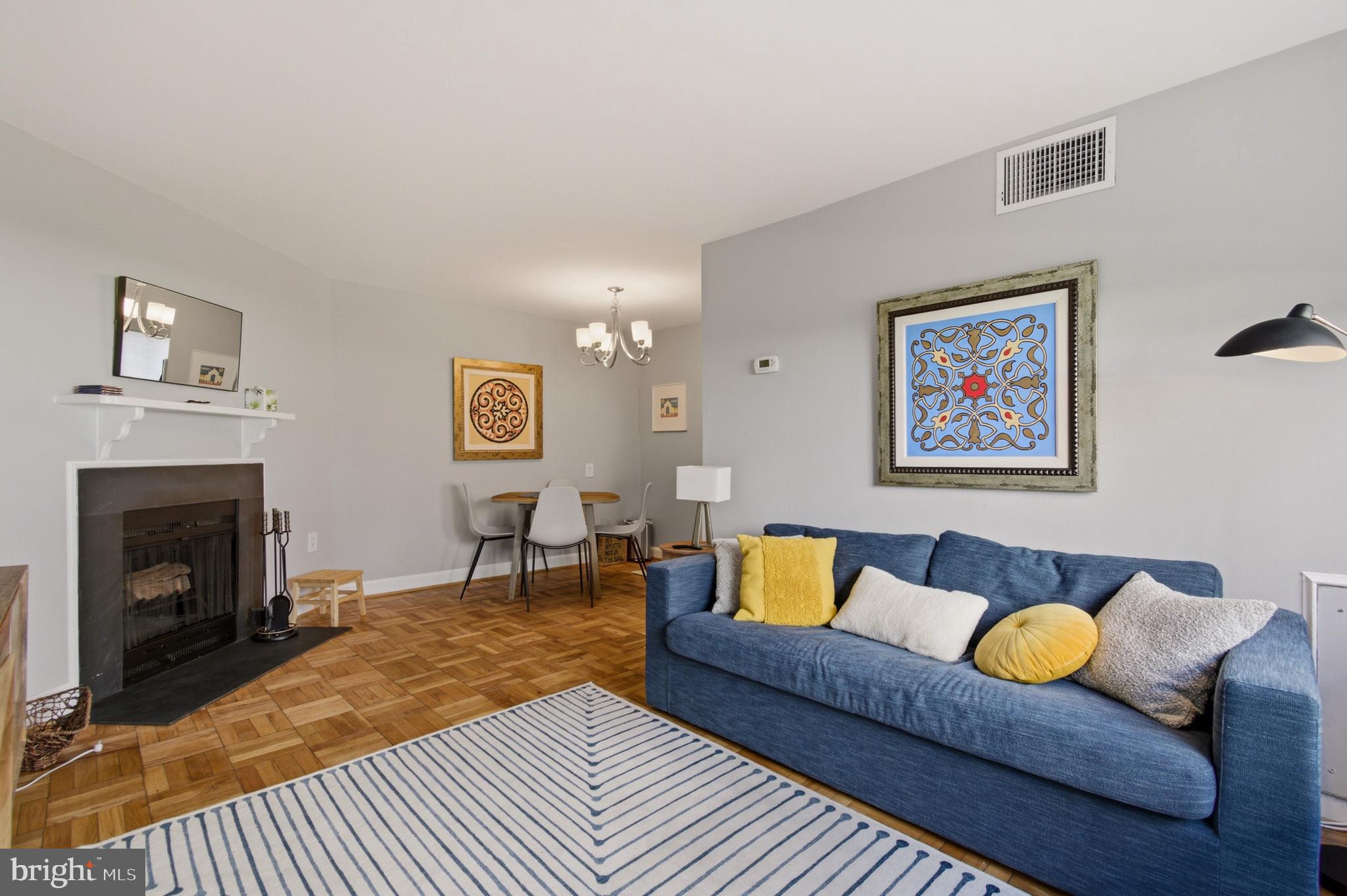 2606 Tunlaw Road Northwest, Unit 2 Washington, DC 20007 - Photo 3 of 14 a living room with furniture a rug and a fireplace