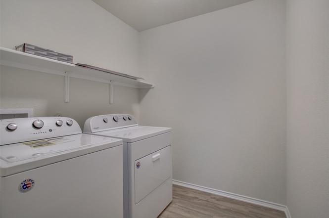 148 Spotted Rail Ridge Leander, TX 78641 - Photo 28 of 31 Ample utility space features functional shelving and contemporary laundry appliances.