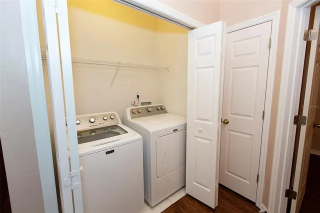 a view of storage and utility room with washer and dryer