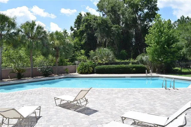 a view of a swimming pool and a yard