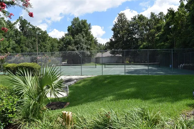 a view of sign board with a wooden fence
