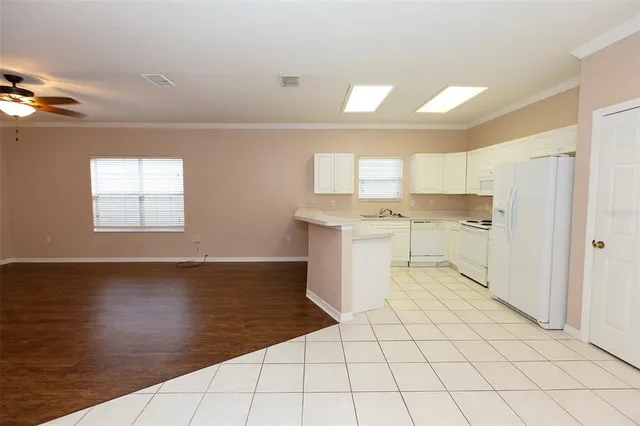 a view of a kitchen with white cabinets