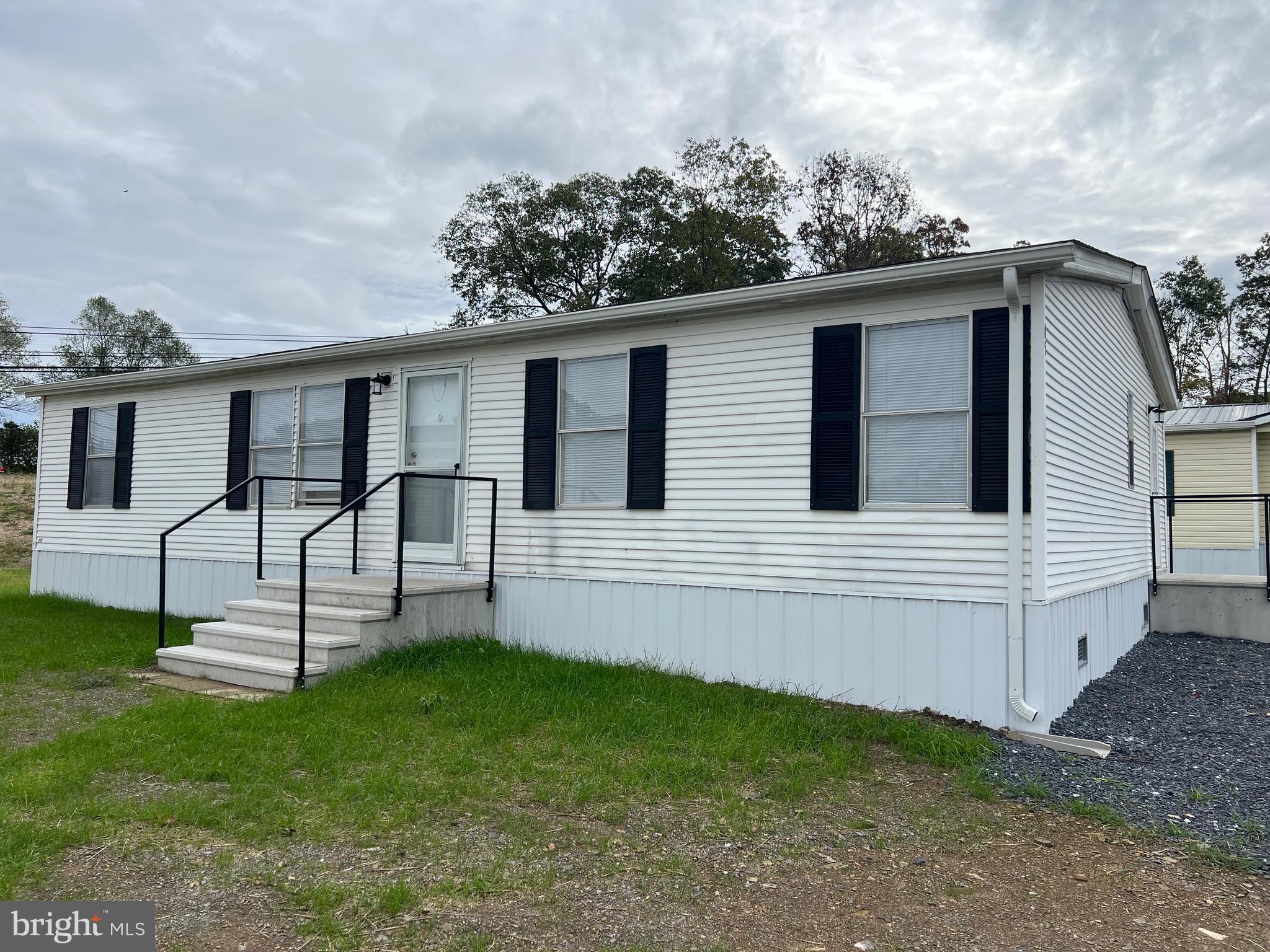 65 Dugan Court Hedgesville, WV 25427 - Photo 1 of 14 a view of a house with a yard and sitting area