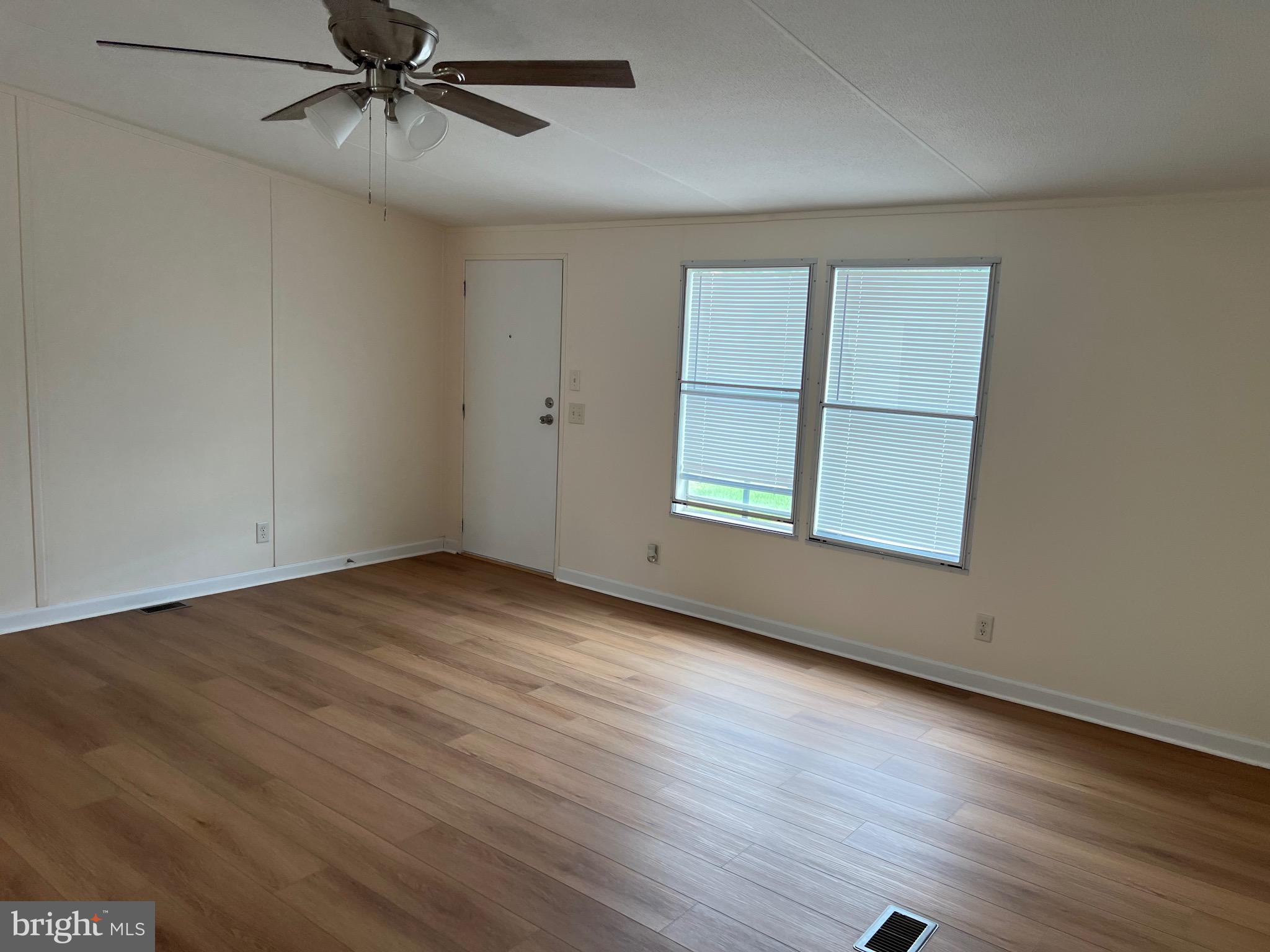 65 Dugan Court Hedgesville, WV 25427 - Photo 11 of 14 an empty room with wooden floor closet and windows