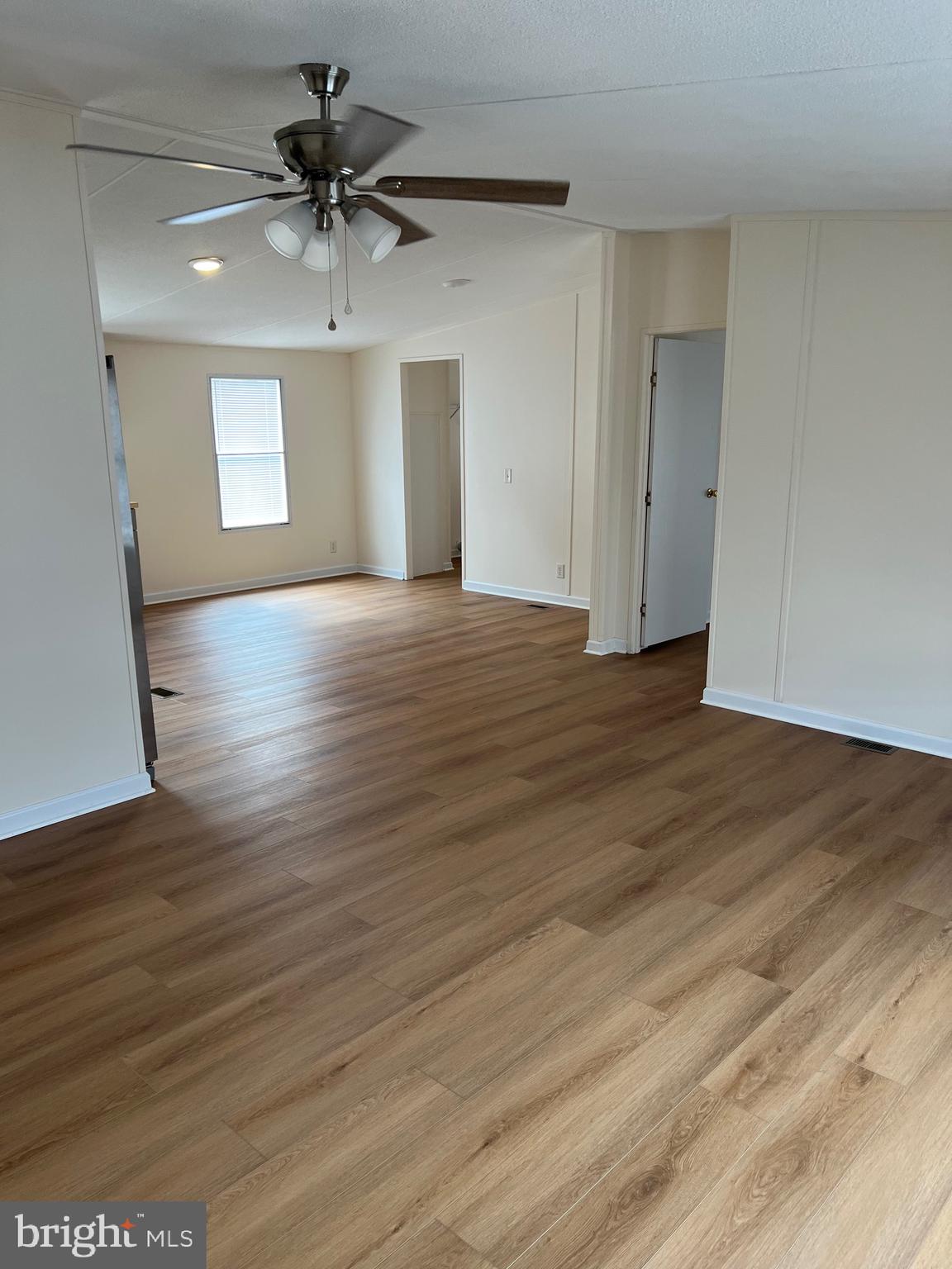 65 Dugan Court Hedgesville, WV 25427 - Photo 12 of 14 a view of an empty room with a window and wooden floor