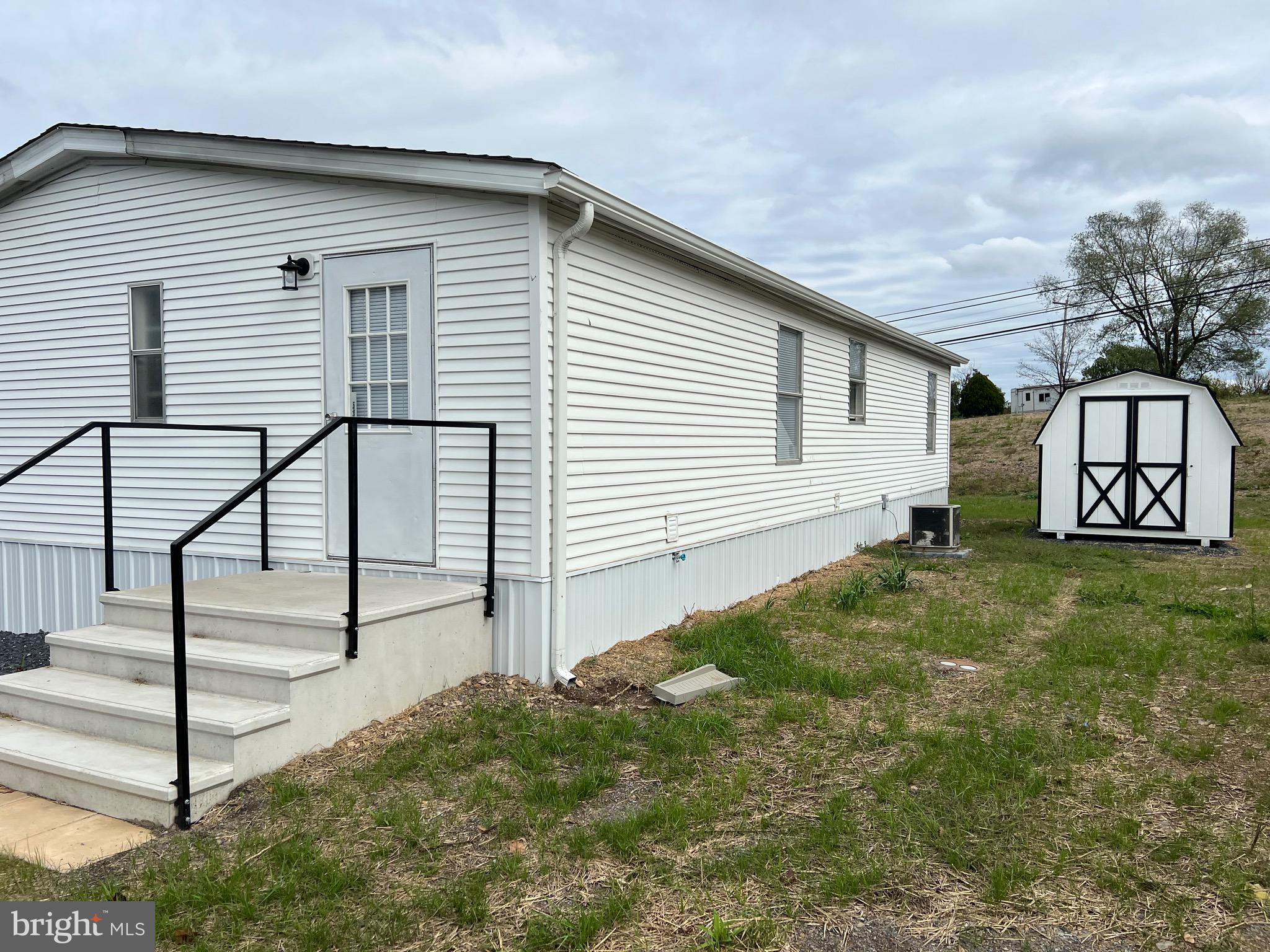65 Dugan Court Hedgesville, WV 25427 - Photo 14 of 14 a view of a white house in front of a yard