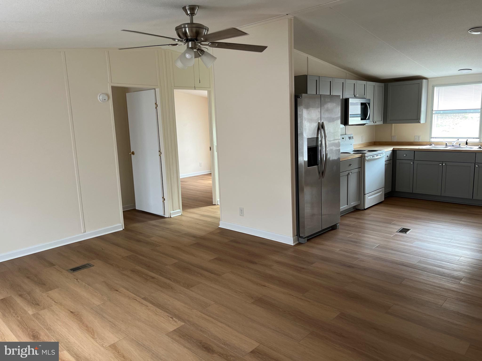 65 Dugan Court Hedgesville, WV 25427 - Photo 2 of 14 a kitchen with granite countertop a refrigerator and a sink
