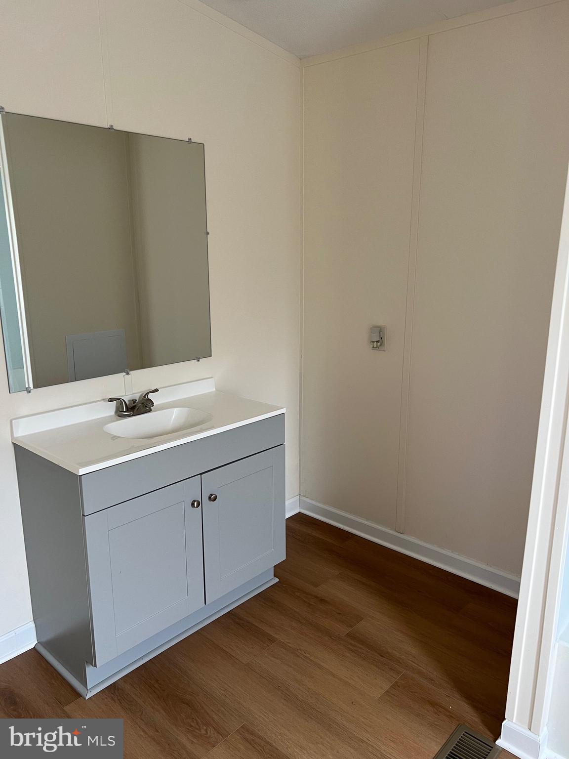 65 Dugan Court Hedgesville, WV 25427 - Photo 5 of 14 a room with a sink cabinets and wooden floor