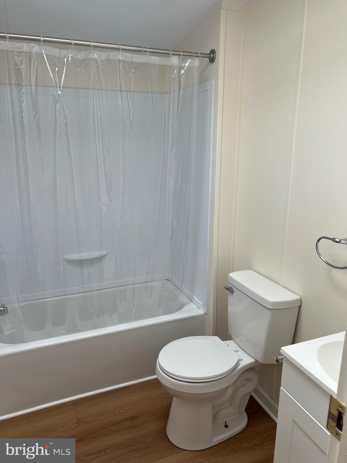 65 Dugan Court Hedgesville, WV 25427 - Photo 10 of 14 a bathroom with a white toilet and a shower curtain