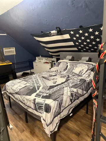 a bed sitting in a bedroom next to a lamp