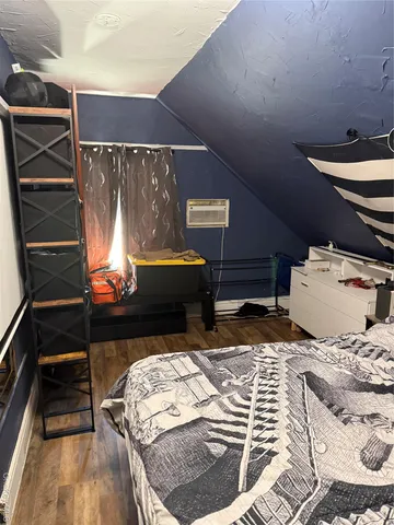 a bed sitting in a bedroom next to a window