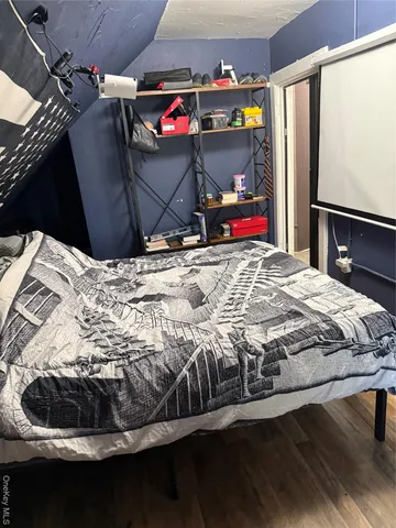 a bed sitting in a bedroom next to a window