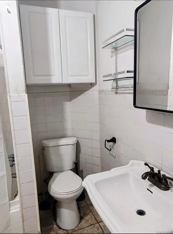 a bathroom with a sink a toilet and mirror