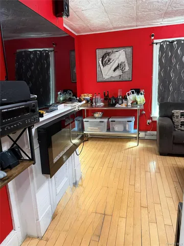 a living room with stainless steel appliances kitchen island granite countertop a stove and a sink