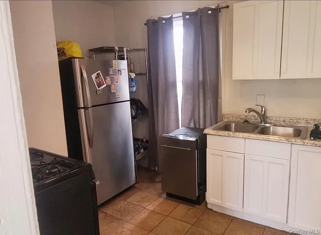 a kitchen with metallic refrigerator freezer and a dishwasher