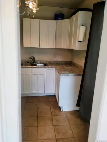a kitchen with a sink a stove and cabinets