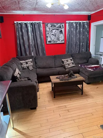 a living room with furniture and a mirror