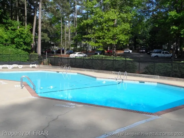 a view of a swimming pool with a yard