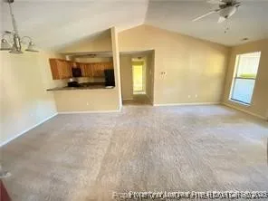 a view of a room with a kitchen