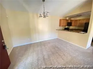 a view of a kitchen with a sink and a refrigerator