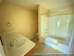 a bathroom with a tub and shower