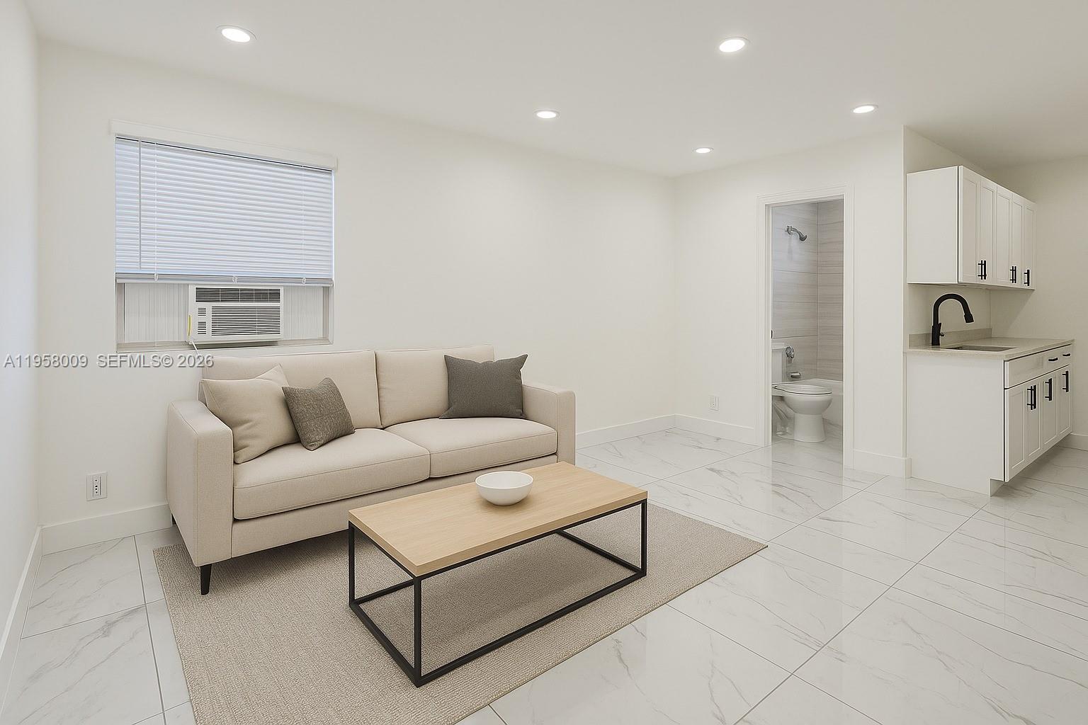 5740 Mayo Street, Unit 4 Hollywood, FL 33023 - Photo 1 of 10 a living room with furniture a refrigerator and a sink