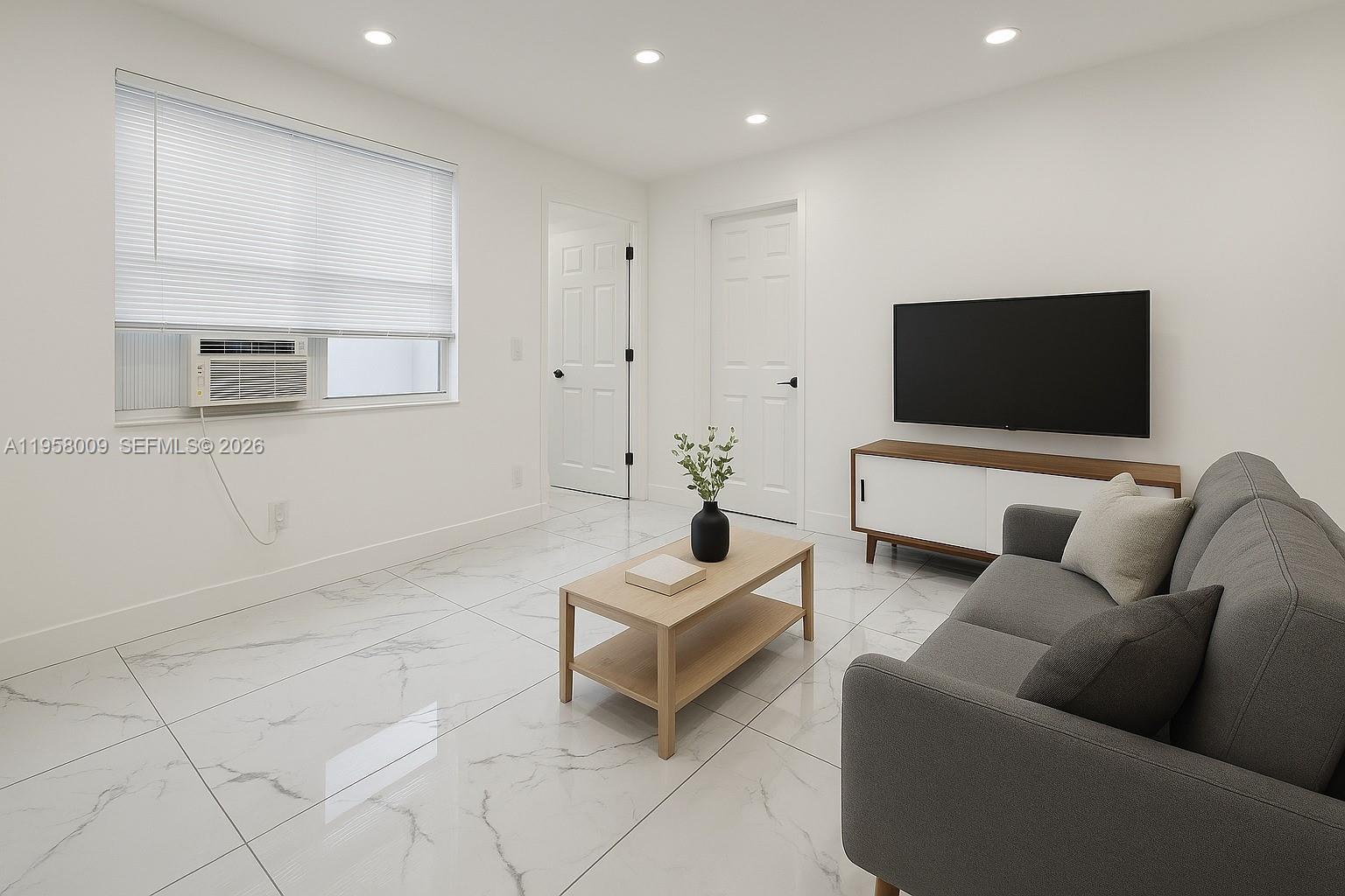 5740 Mayo Street, Unit 4 Hollywood, FL 33023 - Photo 5 of 10 a living room with furniture and a flat screen tv