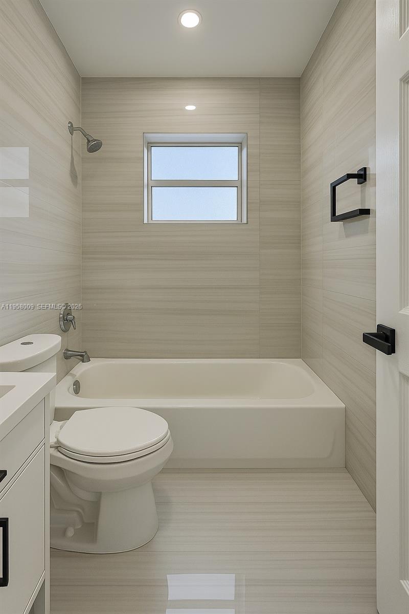 5740 Mayo Street, Unit 4 Hollywood, FL 33023 - Photo 7 of 10 a bathroom with a toilet and a bathtub