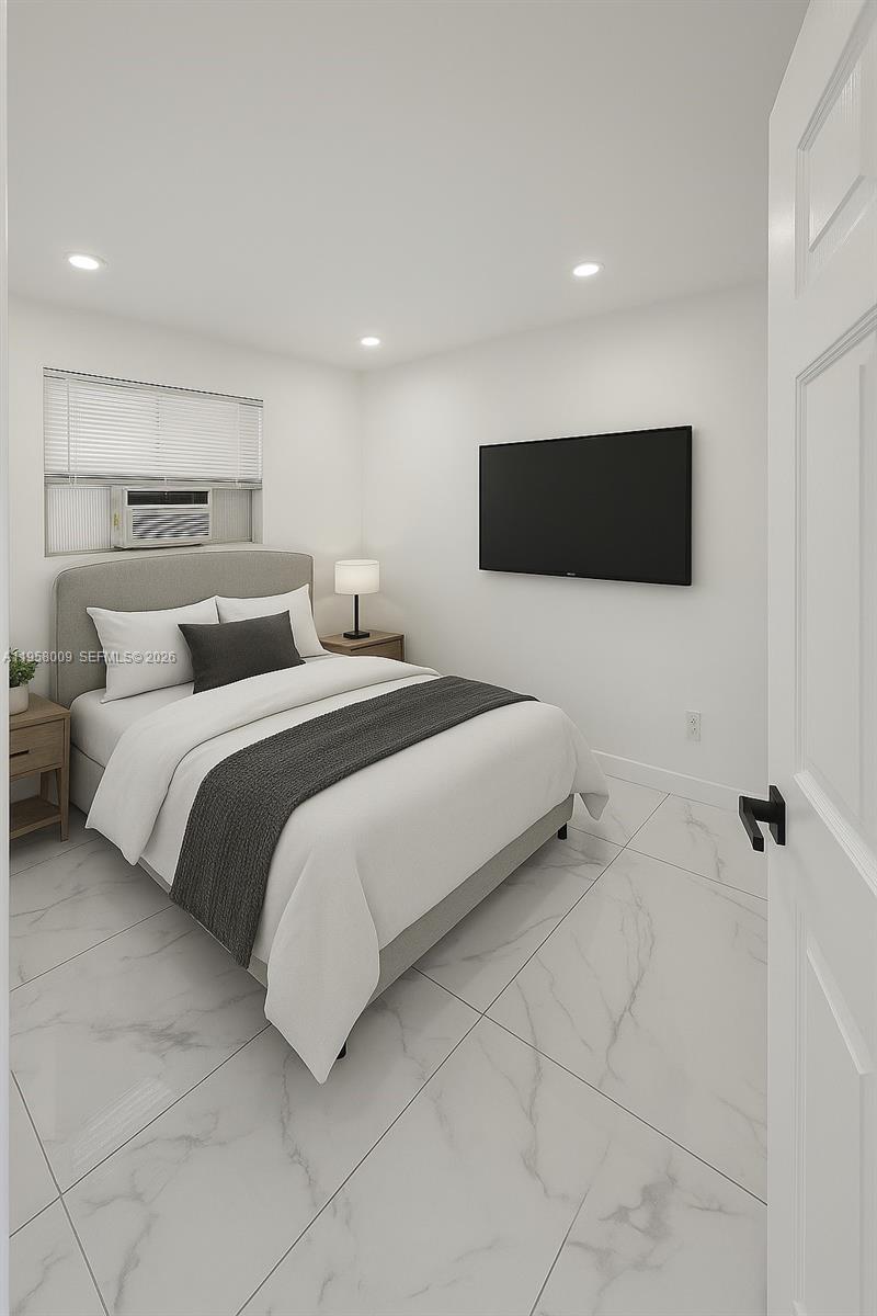 5740 Mayo Street, Unit 4 Hollywood, FL 33023 - Photo 9 of 10 a bedroom with a bed and a flat screen tv