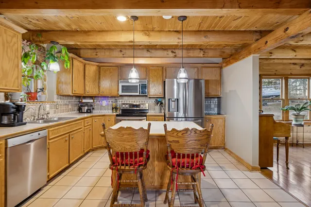 a view of a deck with table and chairs and wooden floor