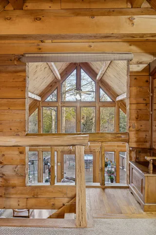 a view of a yard with a house and a large tree