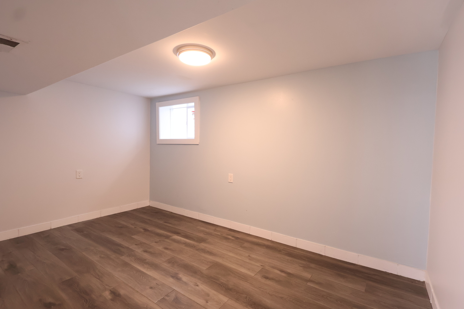 15239 Vincennes Road Phoenix, IL 60426 - Photo 20 of 24 an empty room with wooden floor and windows