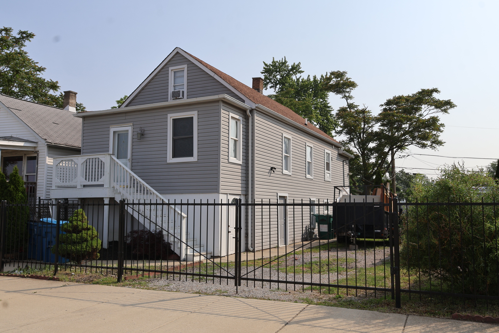 15239 Vincennes Road Phoenix, IL 60426 - Photo 2 of 24 a front view of a house with a porch