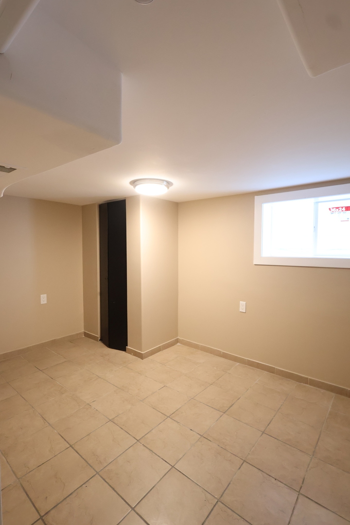 15239 Vincennes Road Phoenix, IL 60426 - Photo 21 of 24 an empty room with a empty space and windows