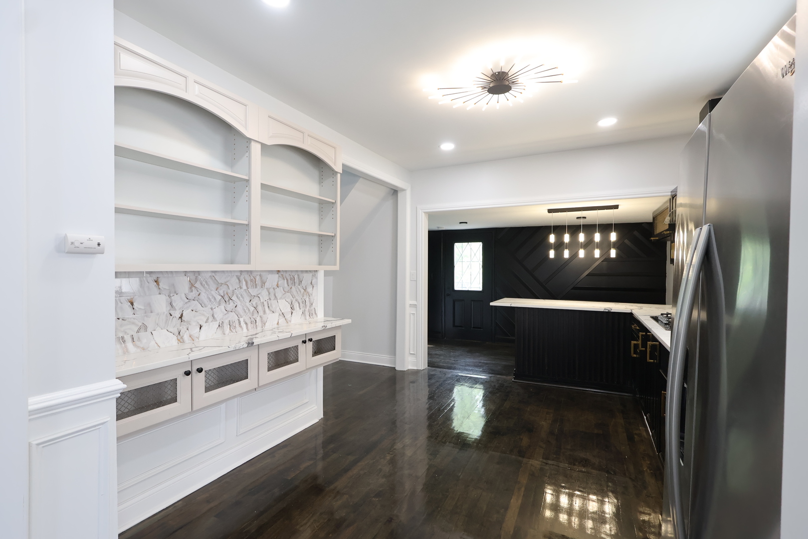 15239 Vincennes Road Phoenix, IL 60426 - Photo 9 of 24 a hallway with cabinets and wooden floor