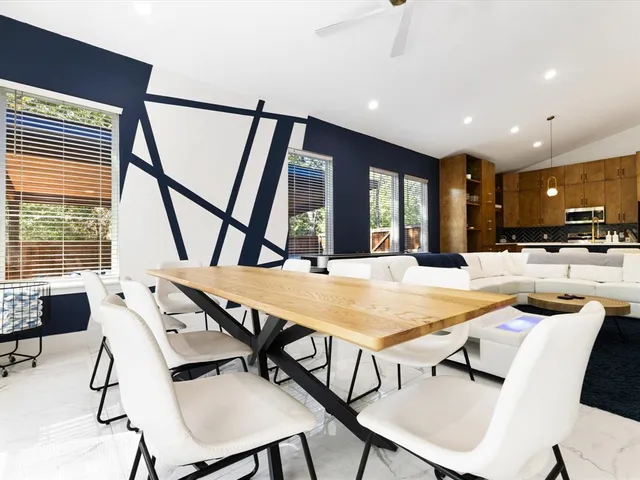 a view of a dining room with furniture and a large window