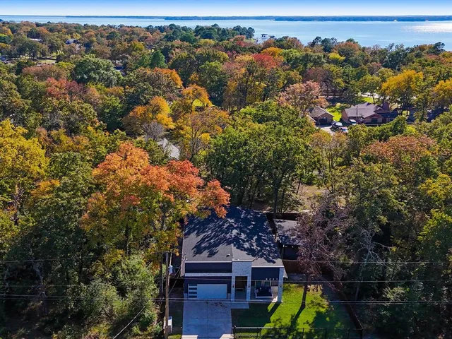 a backyard of a house with wooden floor and fence