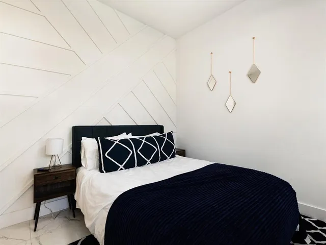 a bedroom with a bed and a chair