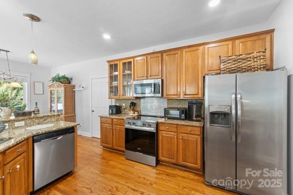 1761 Lakeland Trail Drive Tega Cay, SC 29708 - Photo 13 of 46 a kitchen with stainless steel appliances granite countertop a refrigerator a stove and a wooden floors