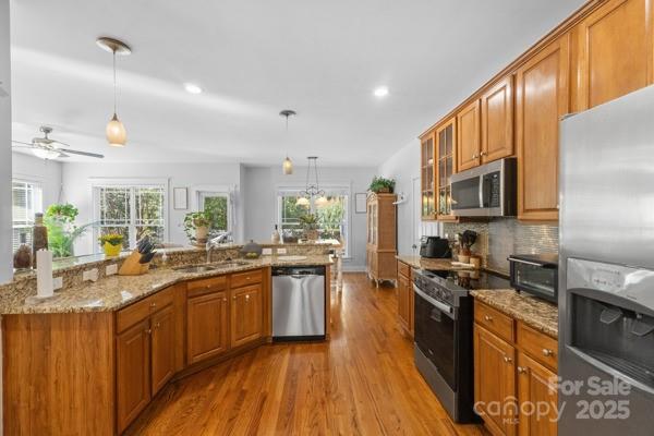 1761 Lakeland Trail Drive Tega Cay, SC 29708 - Photo 14 of 46 a large kitchen with stainless steel appliances granite countertop a sink stove microwave refrigerator and cabinets