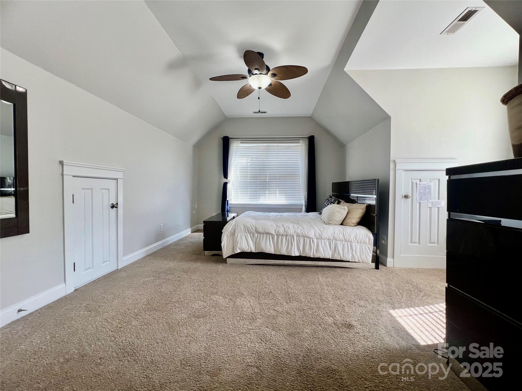 1761 Lakeland Trail Drive Tega Cay, SC 29708 - Photo 22 of 46 a bedroom with a large bed and a chandelier